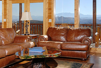 Vaulted ceilings throughout the main living area with floor to roof windows overlooking a mountain view